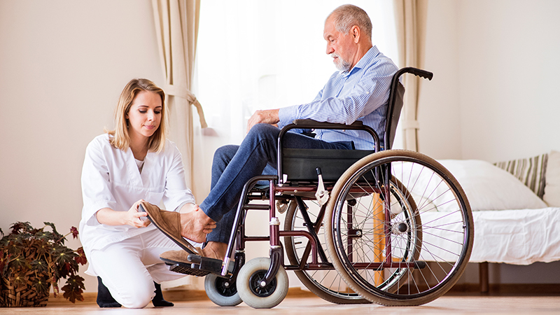 Support worker helping senior client in wheelchair