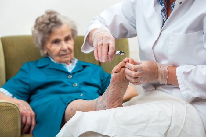 Senior receiving footcare