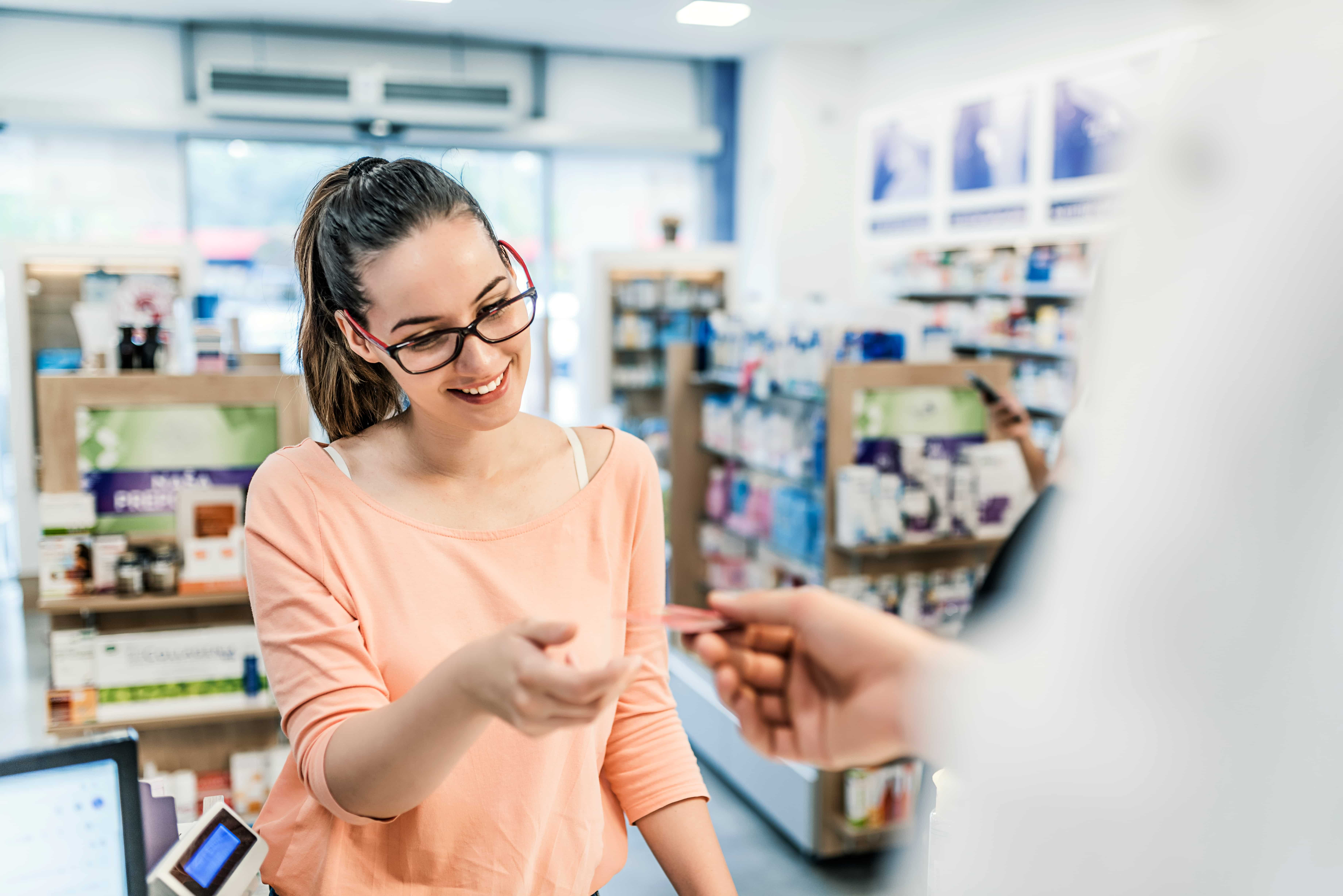 Person at pharmacy with health card